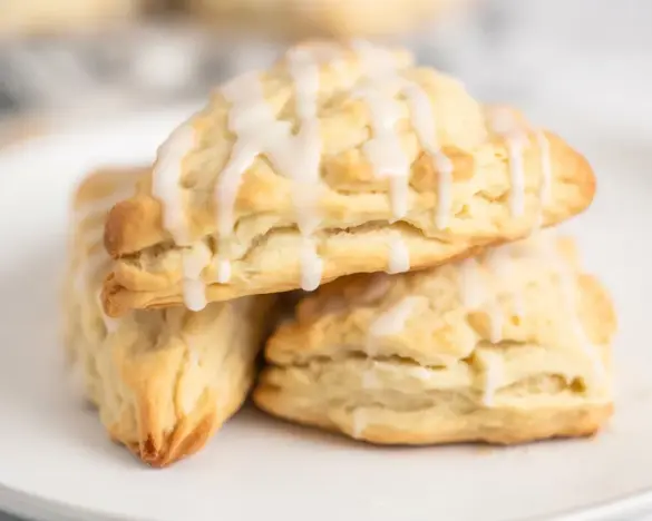 Dairy-Free Lemon Scones topped with tangy lemon glaze, perfect for any occasion.