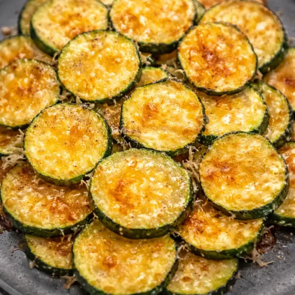 Delicious Baked Parmesan Zucchini topped with cheese, garlic, and herbs.