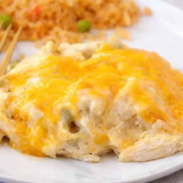Creamy Sour Cream Chicken Enchilada Casserole with layers of chicken, cheese, and tortillas.